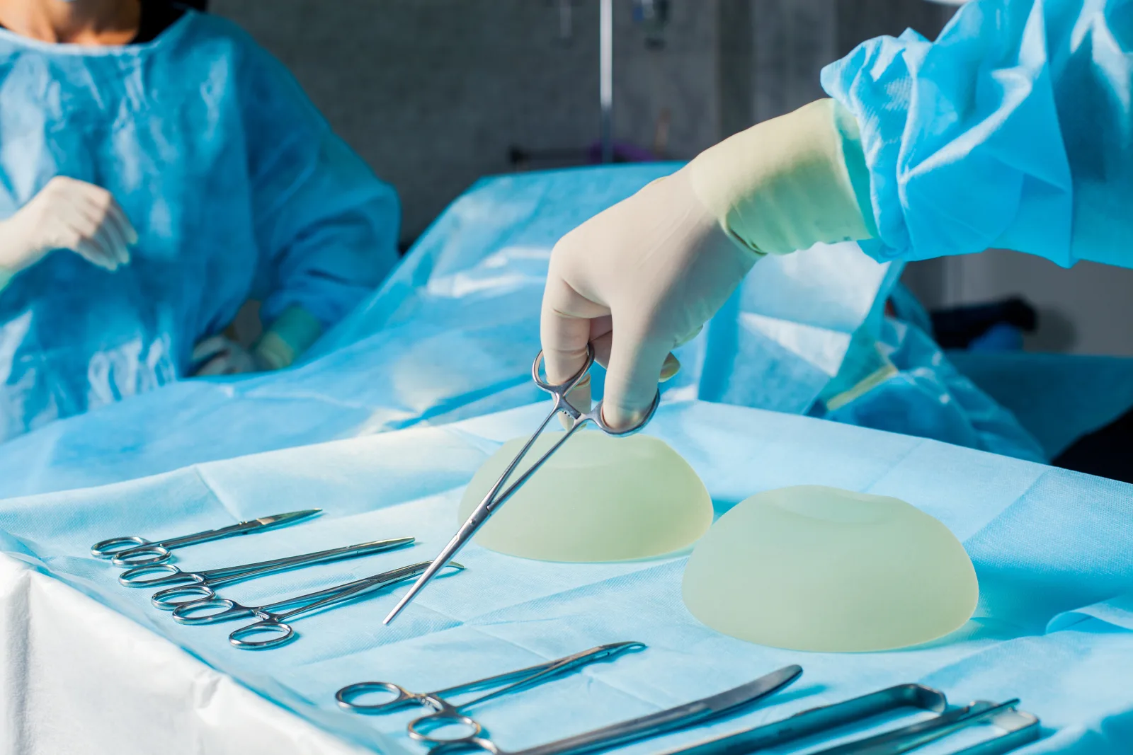 Brustimplantate und chirurgische Instrumente im Operationssaal